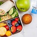 The 3-Day Military Diet: What Actually Happens on the Scale Balanced packed lunch with a wrap, cucumber slices, grains, crackers, berries, banana, apple, muffin, and water bottle.
