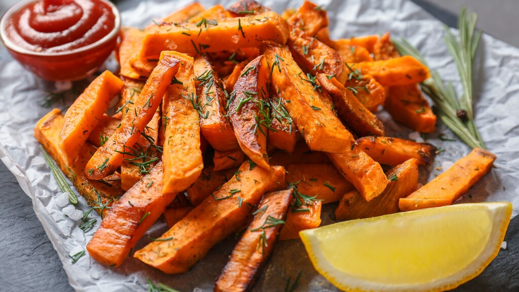 Roasted sweet potato fries with herbs, lemon, and dipping sauce.
