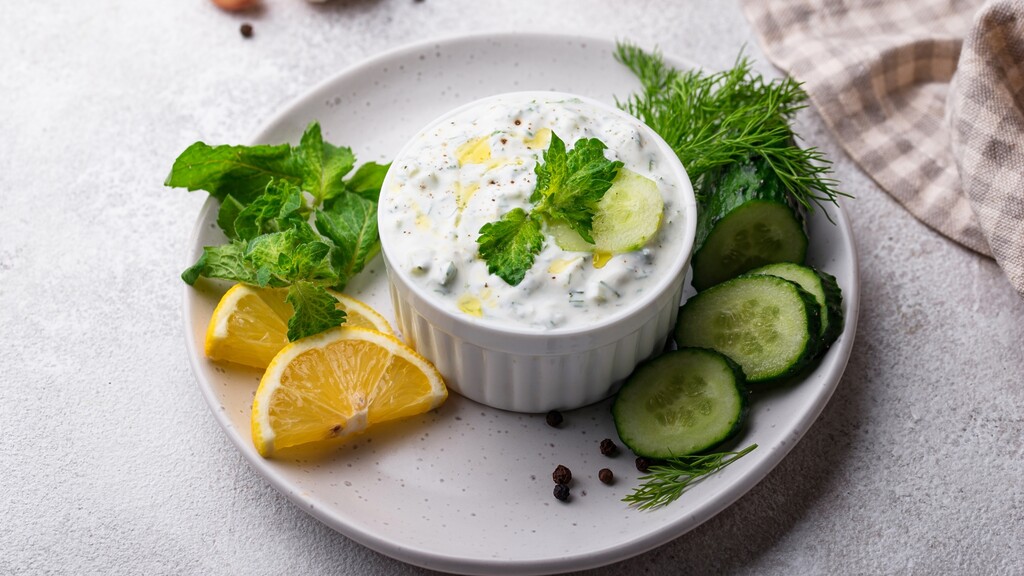 Plain Greek yogurt dip served with cucumber, lemon, mint, and herbs.