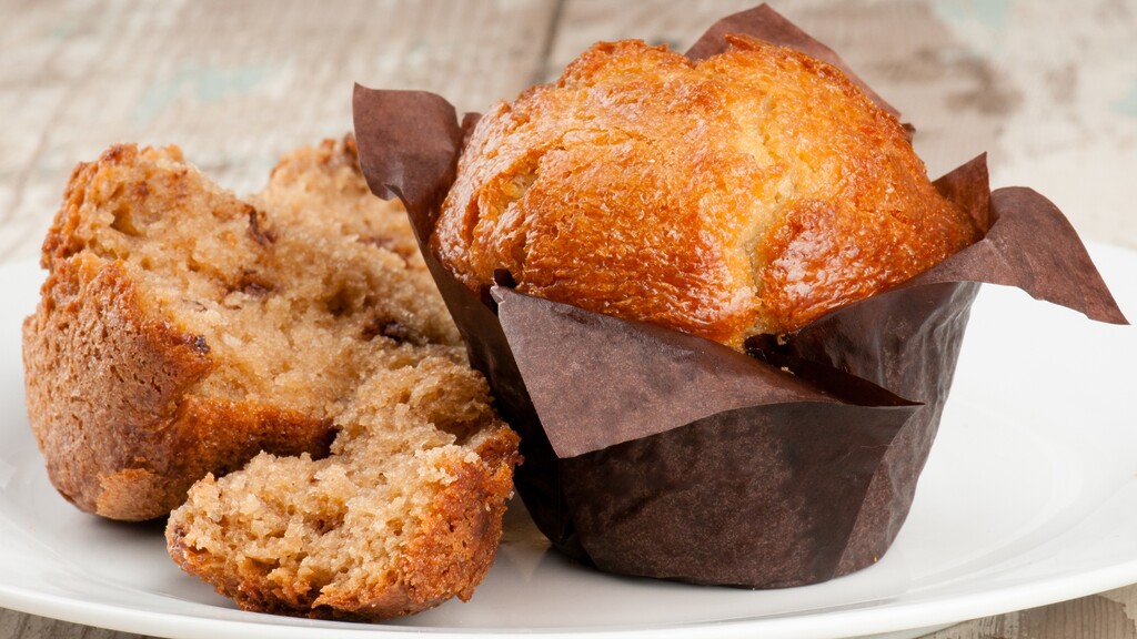 Golden low-carb muffin broken open to show a moist, tender crumb inside.
