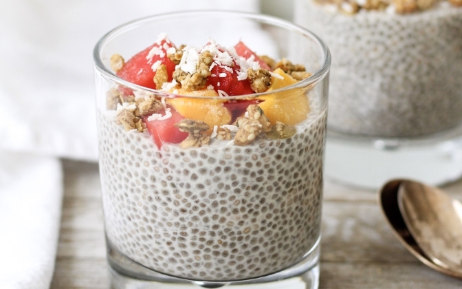 Layered chia pudding dessert with berries and nuts