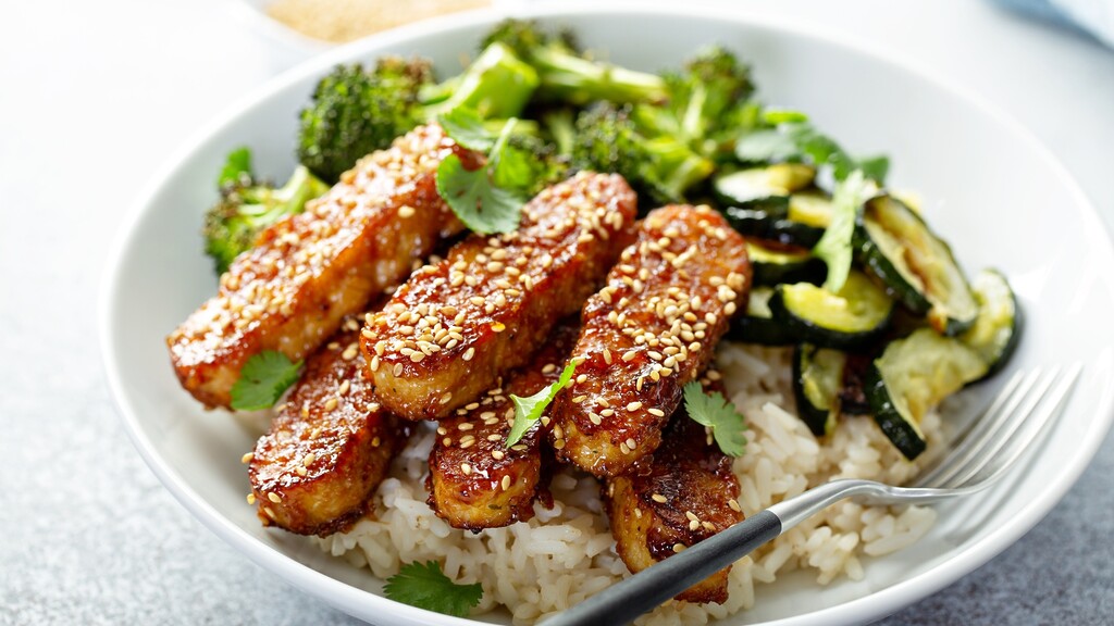 Sesame-glazed tempeh served over rice with roasted broccoli and zucchini.