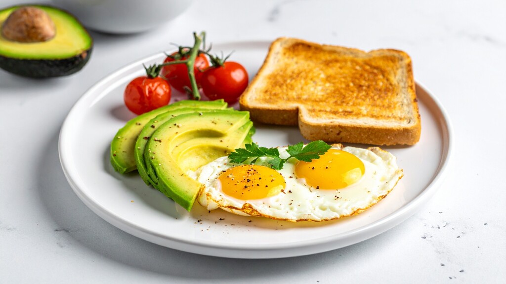 4. Protein-rich breakfast plate with eggs, avocado, tomatoes, and toast for steady morning energy.