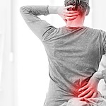 A person holding their neck and lower back with red pain highlights, showing neck and back pain from muscle tension.