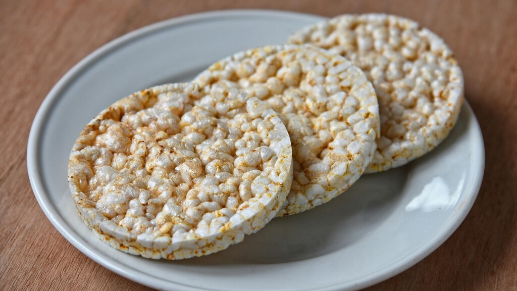 Plain rice cakes stacked on a small white plate.