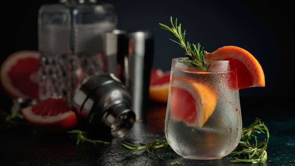 Vodka soda with grapefruit and rosemary served in a chilled glass.
